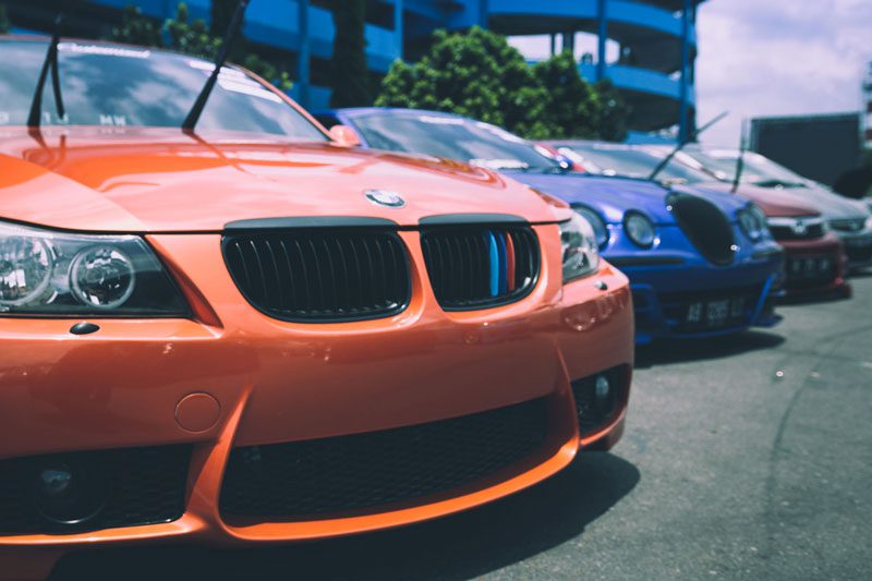 orange bmw on the front with other european cars lining up the back