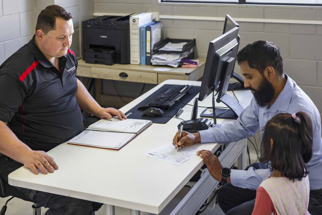 eben the owner consulting with a client for audi service