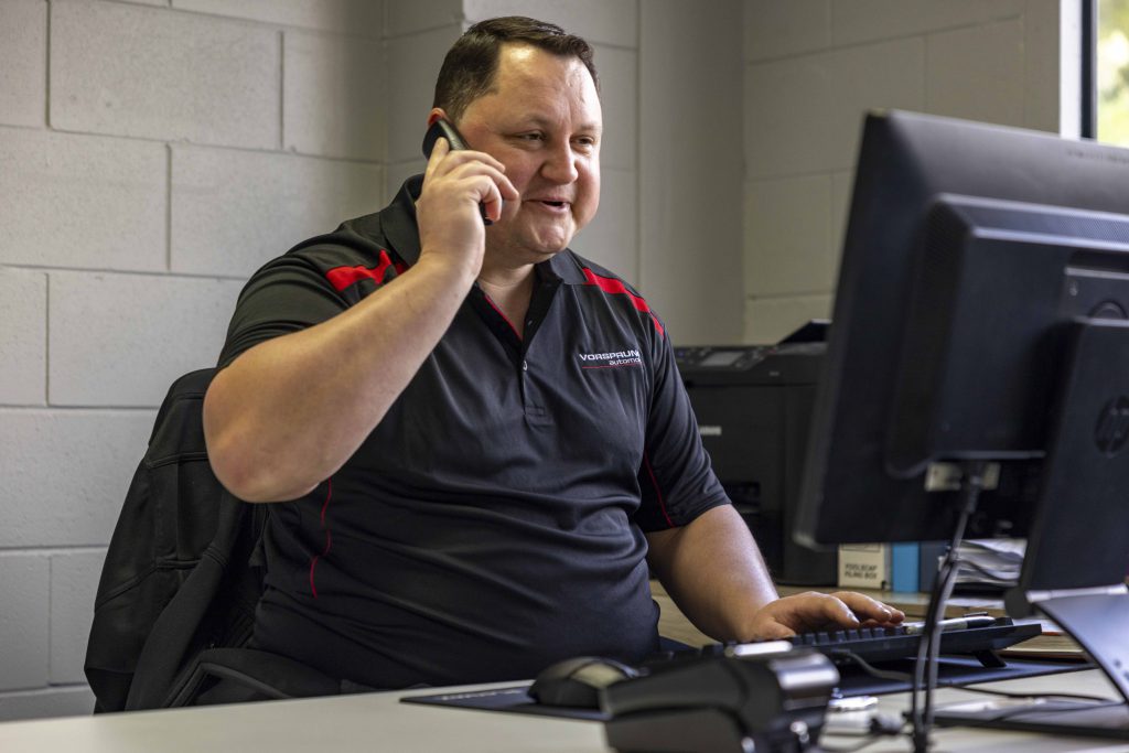 Eben the owner at Vorsprung Automobil answering the phone from a local client to answer questions