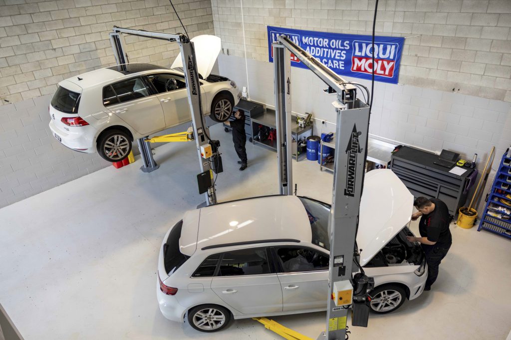 two white european cars from campbells bay getting service in the workshop
