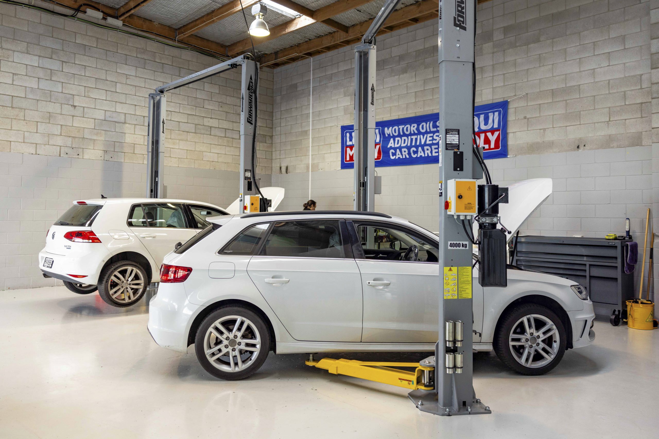 Audi A3 and VW Golf on hoists at Vorsprung Automobil workshop in Rosedale