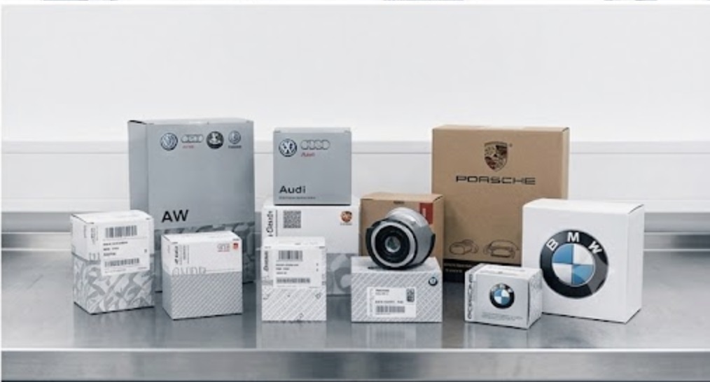 Genuine OEM European car parts for Audi, VW, BMW, and Porsche displayed on a metal workbench