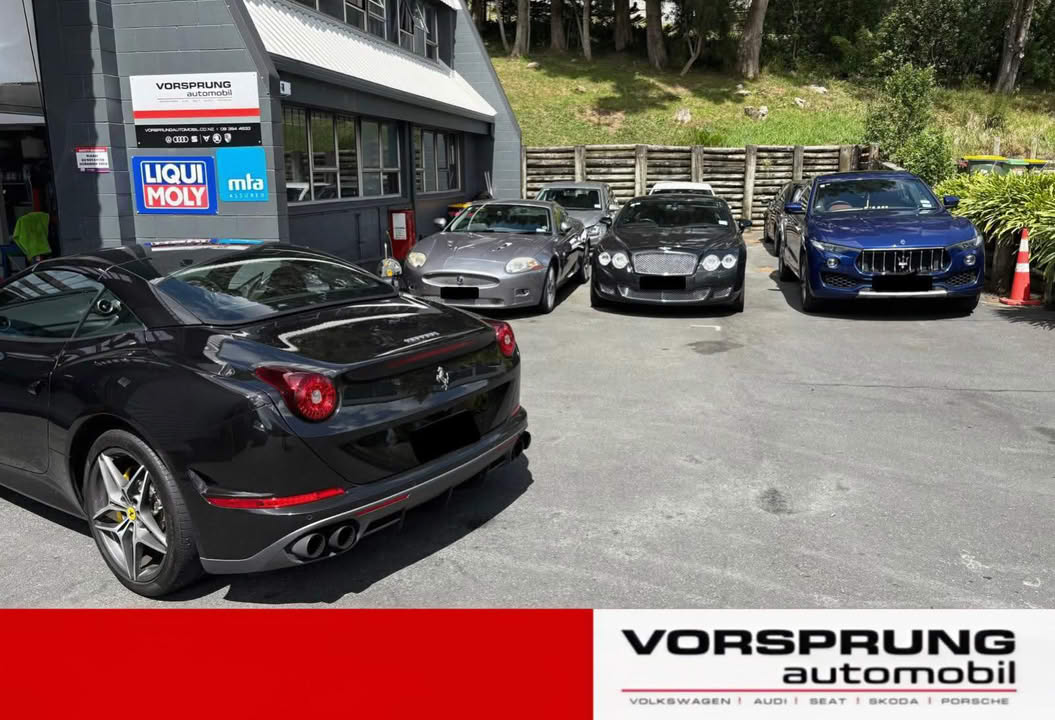 black ferrari and other european cars parked at vorsprung automobil