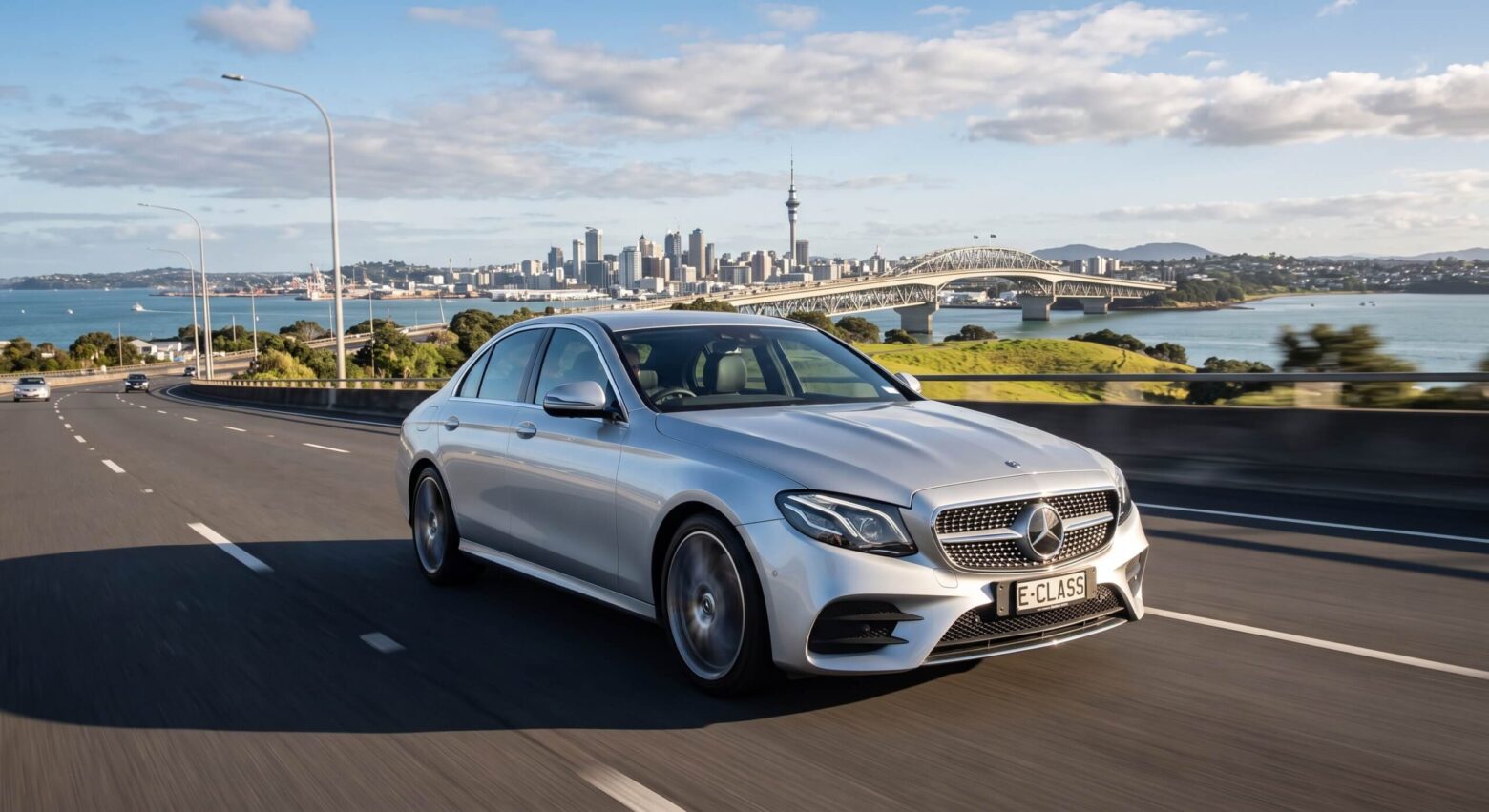 silver mercedes benz driving on the open road of Auckland