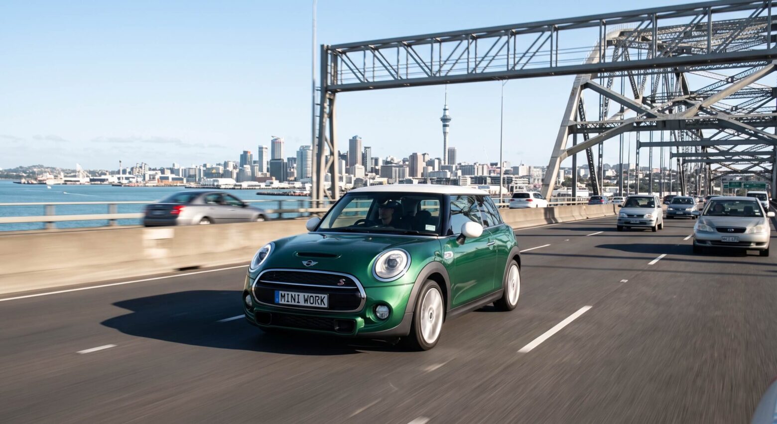 green mini running on the motor way of Auckland